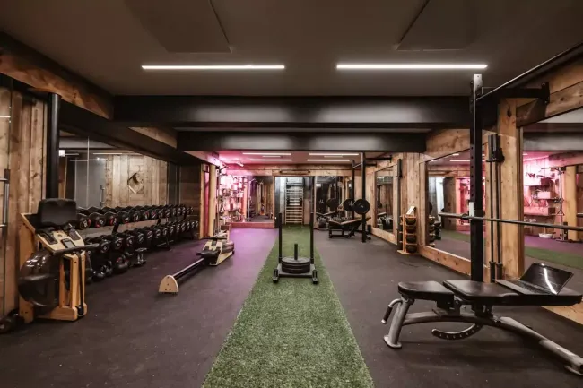 Private home gym with reclaimed timber walls, London — the kind of room the Steam Room is designed for