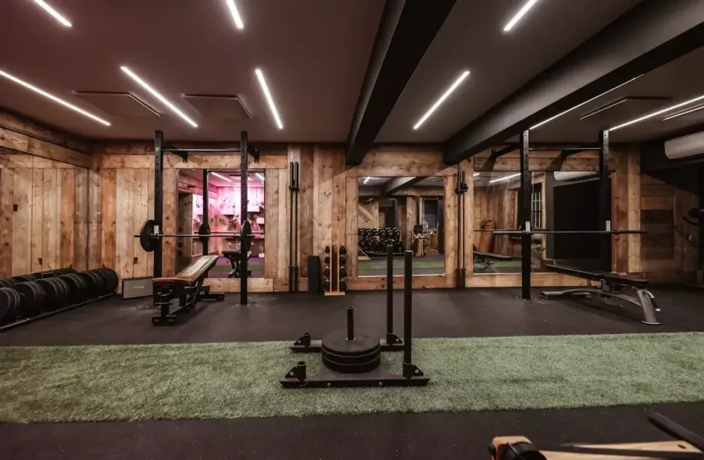 Training room with reclaimed timber walls and free weights