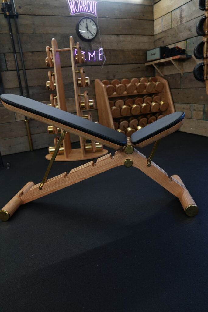 Hand-built wooden free-weight rack in a private gym