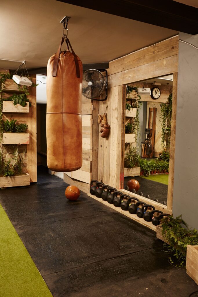 Private home gym with reclaimed timber walls, London — the kind of room the Treadmill is designed for