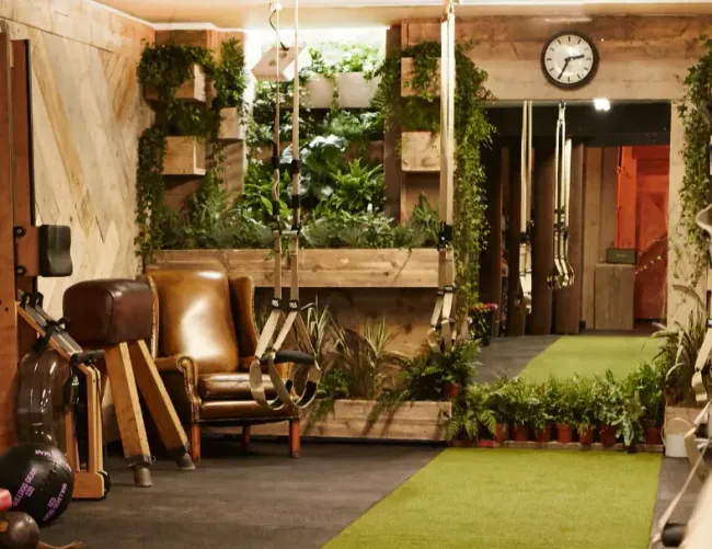 Private studio with reclaimed timber walls, vertical planters and a vintage clock