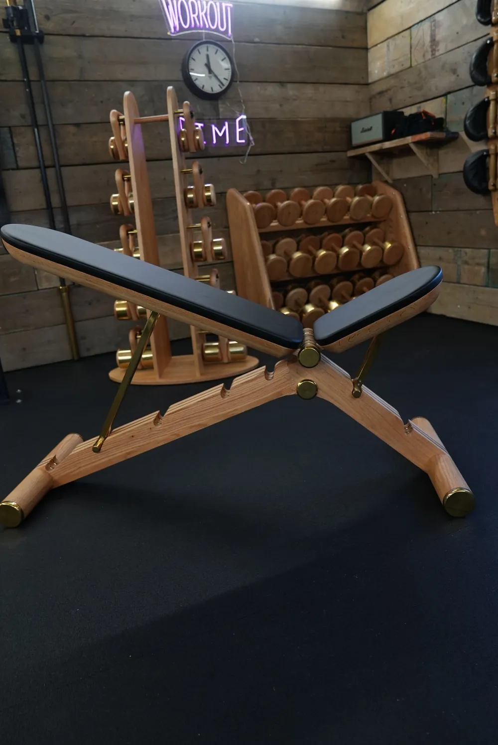 Hand-built wooden free-weight rack in a private gym